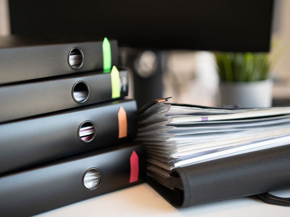 Ring binders of records filed on a shelf