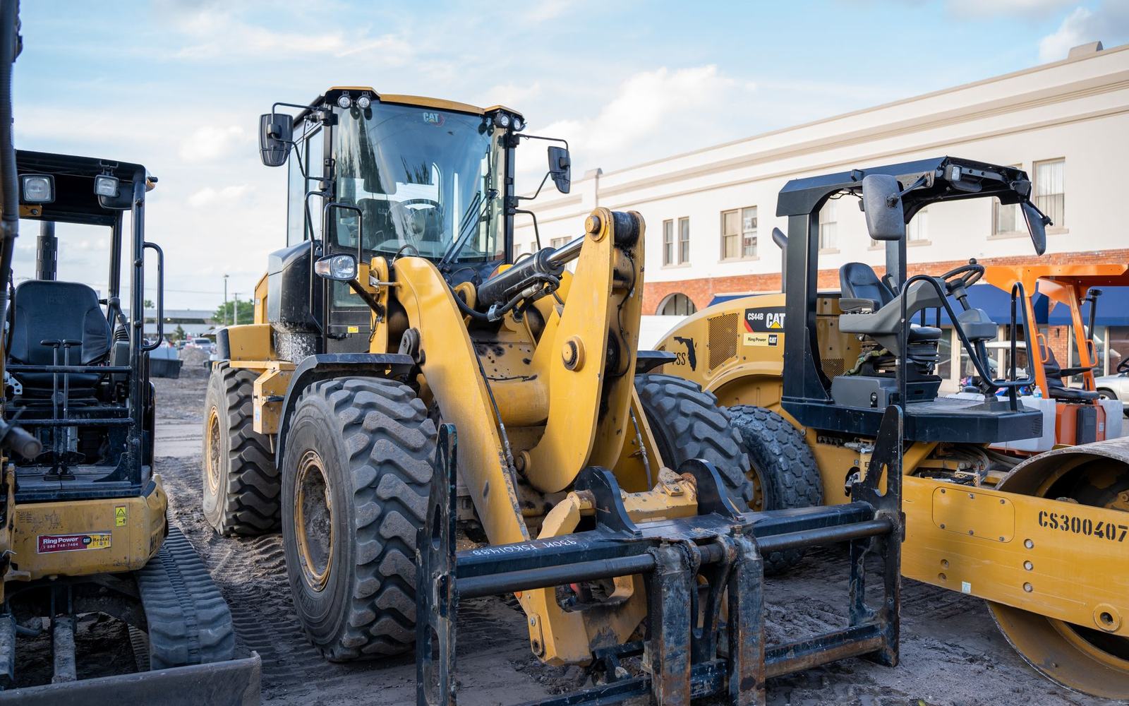 Auction team on site among vehicles and equipment
