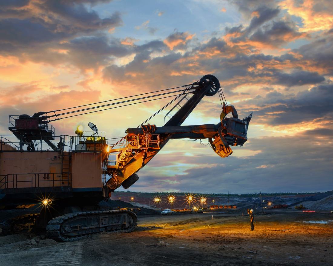 A mining shovel loading at an open cast site at sunset