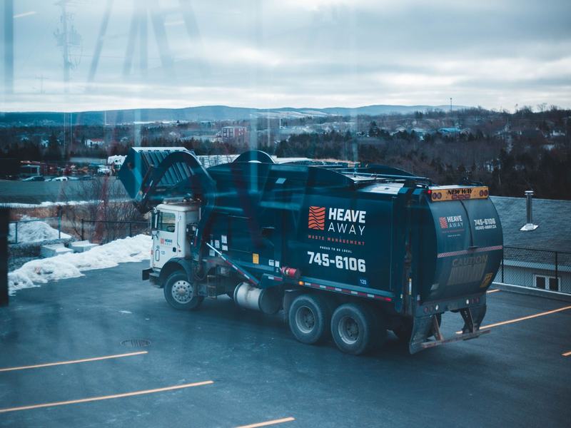 Refuse compactor truck parked at a municipal depot