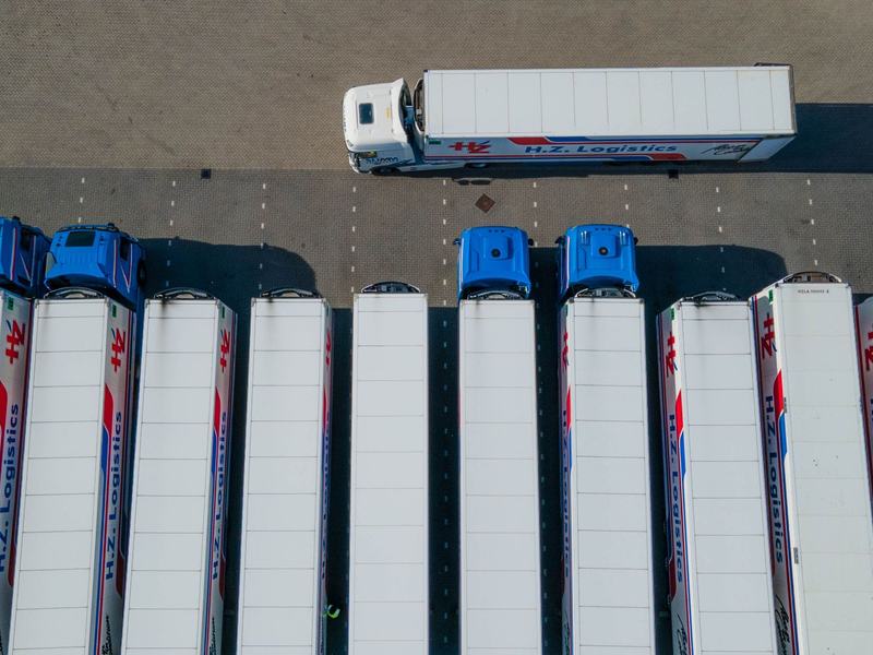 Trucks and trailers parked in rows seen from above