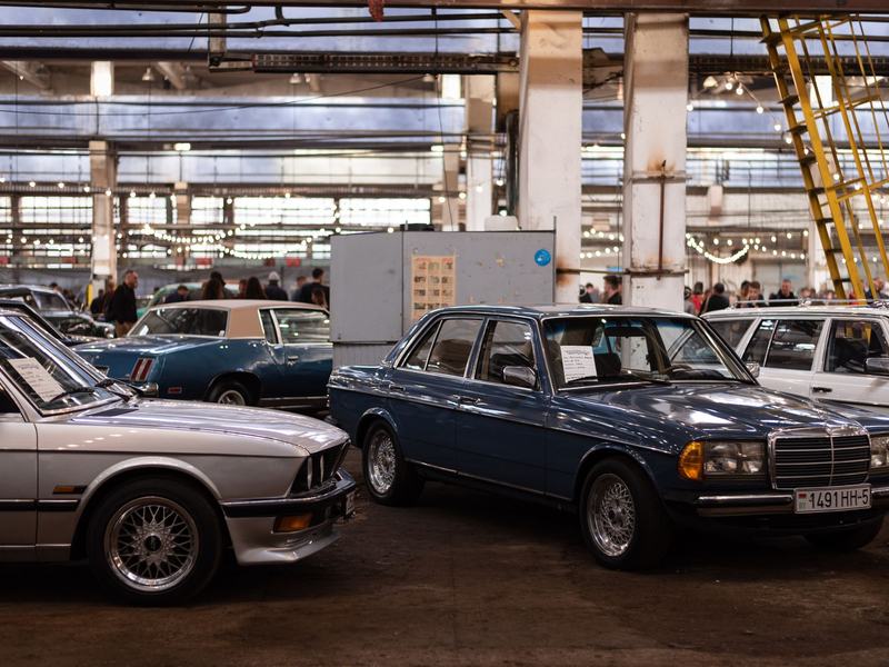 Vehicles lined up in a hall during a live auction