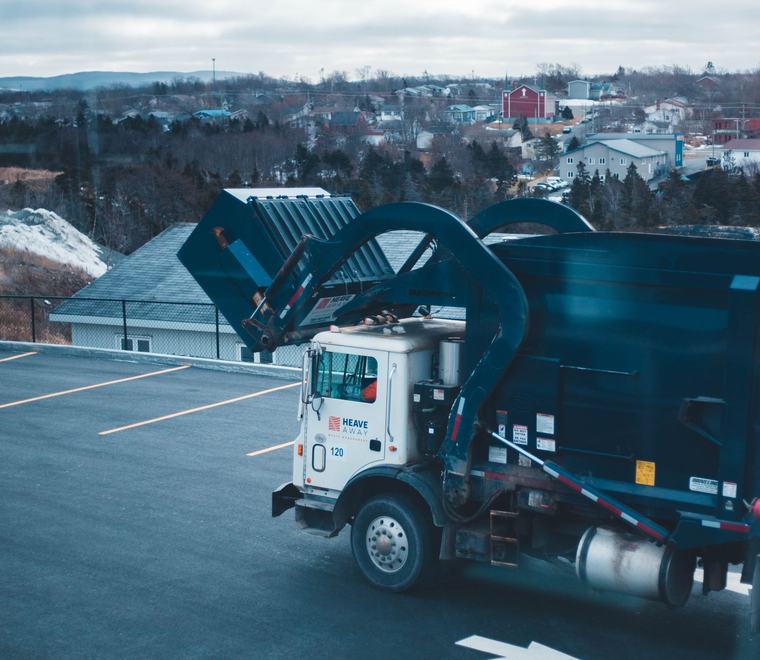 Municipal refuse truck in a depot yard